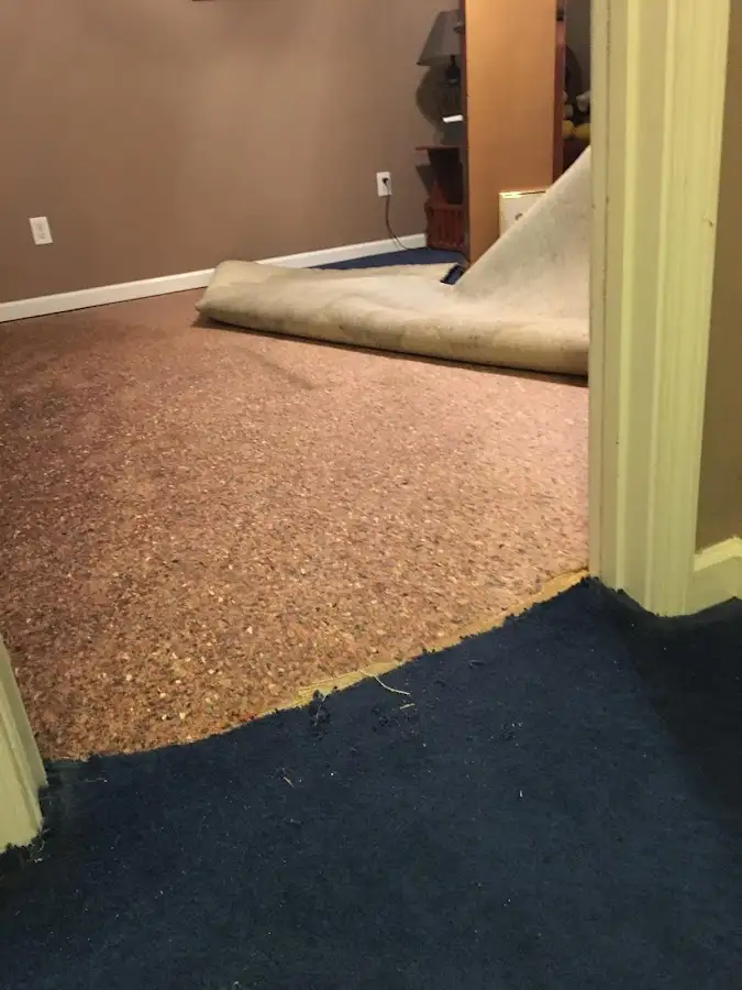 Carpet pad removal revealing water damage during Water Mitigation Services in Irvine